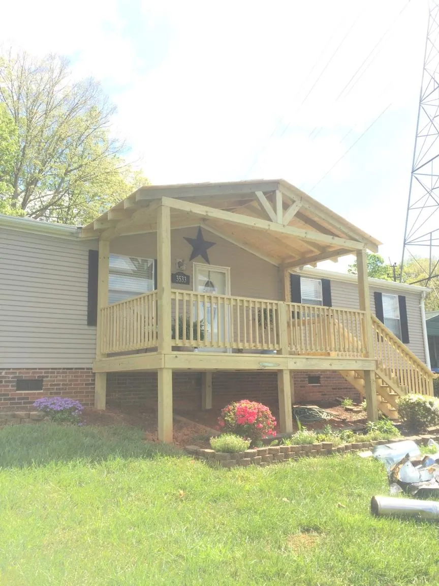 New gabled porch roof and deck railing added to a ranch home in Plymouth